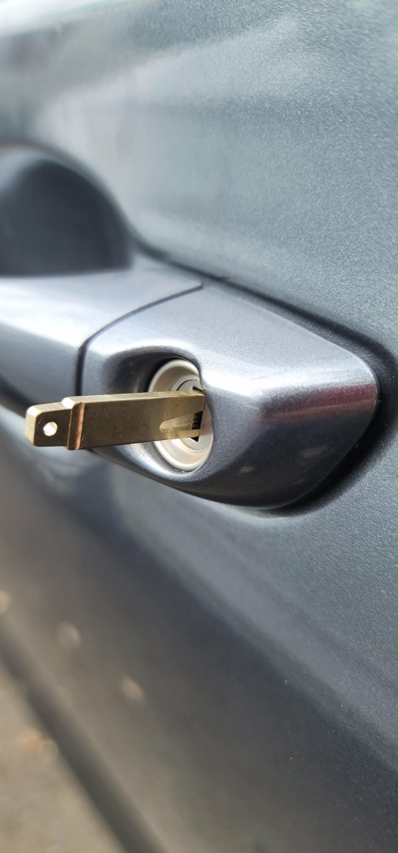 A broken key extraction tool inserted in a car door lock
